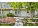 Cozy front porch with a chair and well-kept garden beds, offering a welcoming entrance to the home at 3485 S Forest St, Denver, CO 80222