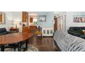 Open-concept living room featuring hardwood floors, natural light, and seamless flow into the adjacent kitchen area at 3485 S Forest St, Denver, CO 80222