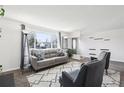 Spacious living room with large windows, neutral decor, and cozy seating area at 214 N 10Th Ave, Brighton, CO 80601