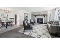 Bright living room with gray brick fireplace, plush rug, and modern decor accents at 214 N 10Th Ave, Brighton, CO 80601