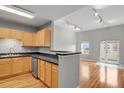 Open floor plan featuring hardwood floors, neutral colors, and natural light, with kitchen view at 1780 N Washington St # 405, Denver, CO 80203