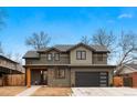 Charming two-story home showcasing neutral siding, a black garage door, and a cozy covered porch at 501 Lois Dr, Louisville, CO 80027