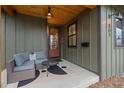 Close-up of front porch featuring a cozy seating area and a stylish front door at 501 Lois Dr, Louisville, CO 80027