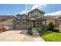 Inviting two-story home with a covered porch, showcasing a well-maintained lawn and attractive landscaping at 190 Olympia Ave, Longmont, CO 80504