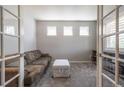 Cozy living room area with comfortable seating, three windows, and view of the living room at 190 Olympia Ave, Longmont, CO 80504
