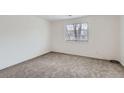 Carpeted bedroom showcasing natural light through the window at 6388 Oak Ct # 203, Arvada, CO 80004