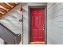 Front entrance with a red door, dark brown trim, and a fire alarm at 6388 Oak Ct # 203, Arvada, CO 80004