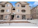 Charming condo building showcasing stone accents, inviting entryways, and well-maintained grounds, ideal for a cozy lifestyle at 8358 S Independence Cir # 105, Littleton, CO 80128