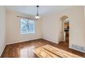 Bright dining room featuring wood floors, natural light, and an open doorway to the kitchen at 2660 Timberchase Trl, Highlands Ranch, CO 80126