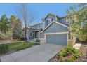 This two story home features a large driveway, two-car garage, a well-manicured lawn and beautiful landscaping at 2660 Timberchase Trl, Highlands Ranch, CO 80126
