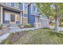 Charming blue home with a well-manicured lawn, stone accents, and a welcoming front entrance at 2660 Timberchase Trl, Highlands Ranch, CO 80126