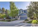 Beautiful two-story blue home with attached garage, landscaped yard, and a 'For Sale' sign at 2660 Timberchase Trl, Highlands Ranch, CO 80126