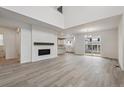 Bright living room with modern fireplace, tall ceilings, and an open floor plan at 9297 Truckee Ct, Commerce City, CO 80022