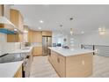 Modern kitchen with stainless steel appliances, sleek countertops, and a large center island for entertaining at 7018 Reed Ct, Arvada, CO 80003
