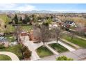 Aerial view showcasing the home's setting among mature trees in a well-established neighborhood at 435 Balsam St, Lakewood, CO 80226