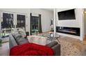 Comfortable living space featuring a modern fireplace, stylish decor, and a seamless indoor-outdoor flow at 4432 Umatilla St, Denver, CO 80211