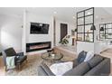 Comfortable living room with sleek fireplace, modern decor, and plush seating arrangement around a glass coffee table at 4432 Umatilla St, Denver, CO 80211