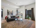 Cozy living room with ample natural light, complemented by a stylish rug and comfortable seating at 4432 Umatilla St, Denver, CO 80211