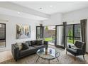 Bright living room featuring modern decor, stylish furniture, and seamless indoor/outdoor flow to a private patio at 4432 Umatilla St, Denver, CO 80211