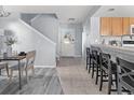 Welcoming entryway with tile flooring, staircase and a view of the adjacent kitchen at 1929 S Xanadu Way, Aurora, CO 80014