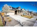 Beautiful home with a large driveway, stone accents, and flowering trees in a well-maintained neighborhood at 469 S Olathe St, Aurora, CO 80017