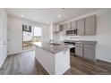Modern kitchen with a granite island, stainless steel appliances, and open floor plan at 22133 E 38Th Pl, Aurora, CO 80019
