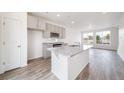 Bright kitchen features a granite island, stainless steel sink, and ample natural light at 22133 E 38Th Pl, Aurora, CO 80019