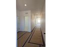 Bright hallway featuring white walls and neutral flooring that leads to the rest of the home at 418 Grey Rock St, Brighton, CO 80601