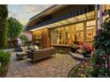 Inviting backyard patio with outdoor seating, stone pavers and a view of the home's exterior at 400 S Steele St # 64, Denver, CO 80209