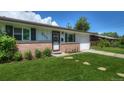 A charming home with a brick facade, lush lawn, and stone pathway leading to the front door at 855 33Rd St, Boulder, CO 80303