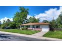 Inviting ranch-style home with a brick facade, attached garage, and lush green lawn on a bright, clear day at 855 33Rd St, Boulder, CO 80303