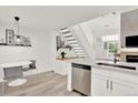 Modern kitchen with view to the staircase, front door, and eat-in dining area at 3030 W Prentice Ave # D, Littleton, CO 80123