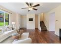 Open living room featuring stylish furniture, updated ceiling fan, access to the backyard and staircase at 12708 W Virginia Ave, Lakewood, CO 80228