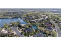 Picturesque aerial view of homes nestled around a serene lake, showcasing the community's lush landscaping at 3 White Pelican Cir, Thornton, CO 80241
