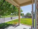 Serene front porch view with a charming flowerbed, overlooking a green neighborhood park and grassy walkway at 6260 E 114Th Ave, Thornton, CO 80233