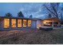 Backyard featuring covered patio, outdoor seating, stone pavers, and charming landscaping at 2605 Crabapple Ct, Golden, CO 80401