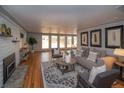Bright living room with hardwood floors, large windows, fireplace, and modern decor at 2605 Crabapple Ct, Golden, CO 80401