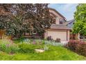 Charming home with meticulously landscaped front yard with flowers and mature trees at 473 Somerset Dr, Golden, CO 80401