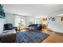 Inviting living room with hardwood floors, large windows, and comfortable seating at 6314 W 92Nd Pl, Westminster, CO 80031