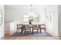 Bright dining room featuring a modern light fixture and large windows at 1272 S Milwaukee St, Denver, CO 80210