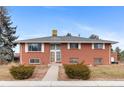 Classic brick home showcasing a traditional design with symmetrical windows and a welcoming front entrance at 4731 W 66Th Ave, Arvada, CO 80003