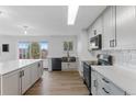 Modern kitchen with white cabinets, stainless steel appliances, and a large island, great for entertaining at 4731 W 66Th Ave, Arvada, CO 80003