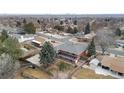 Aerial view of the backyard, including a wooden fence, trees, and a glimpse of the house with a sunroom at 4731 W 66Th Ave, Arvada, CO 80003