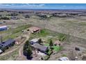 Expansive aerial view showcasing the property, surrounding farmland, and serene countryside, creating a peaceful atmosphere at 7605 Shenandoah Dr, Elizabeth, CO 80107