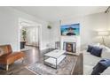 Bright living room boasts fireplace, hardwood floors, neutral paint, and open dining room at 142 N Logan St, Denver, CO 80203