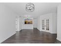 Spacious living room with hardwood floors, modern lighting, and an open view of the kitchen at 5255 Memphis St # 1112, Denver, CO 80239
