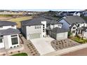 An aerial view showcasing the home's modern design, set within a community with mountain views in the distance at 455 Rogers Way, Castle Rock, CO 80104