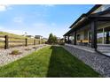 Lovely backyard featuring a lush lawn, rock landscape, and fencing, perfect for outdoor enjoyment and relaxation at 455 Rogers Way, Castle Rock, CO 80104