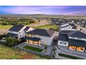 Backyard view shows the home's full-length covered porch, fenced yard and gravel landscaping at 455 Rogers Way, Castle Rock, CO 80104
