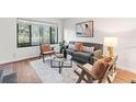 Bright living room with large window, comfortable seating, and stylish decor for a relaxing atmosphere at 2297 S Oswego Way, Aurora, CO 80014